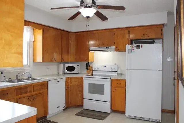 Before - dated Red Deer kitchen with original cabinets