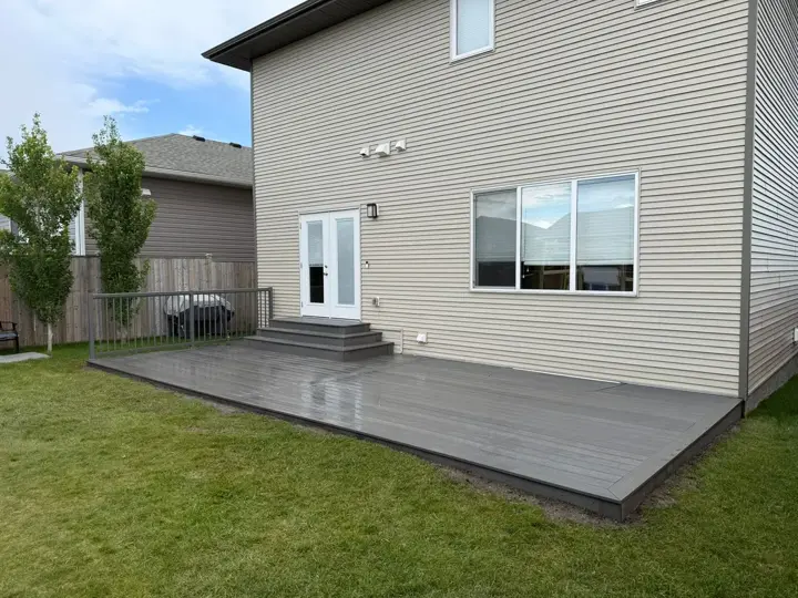 Single level 27 by 12 foot Eva-Last bamboo composite deck with aluminum railing in Red Deer, AB - built by Green Ladder Contractors